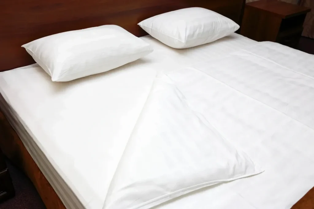 White bed with sheets turned up