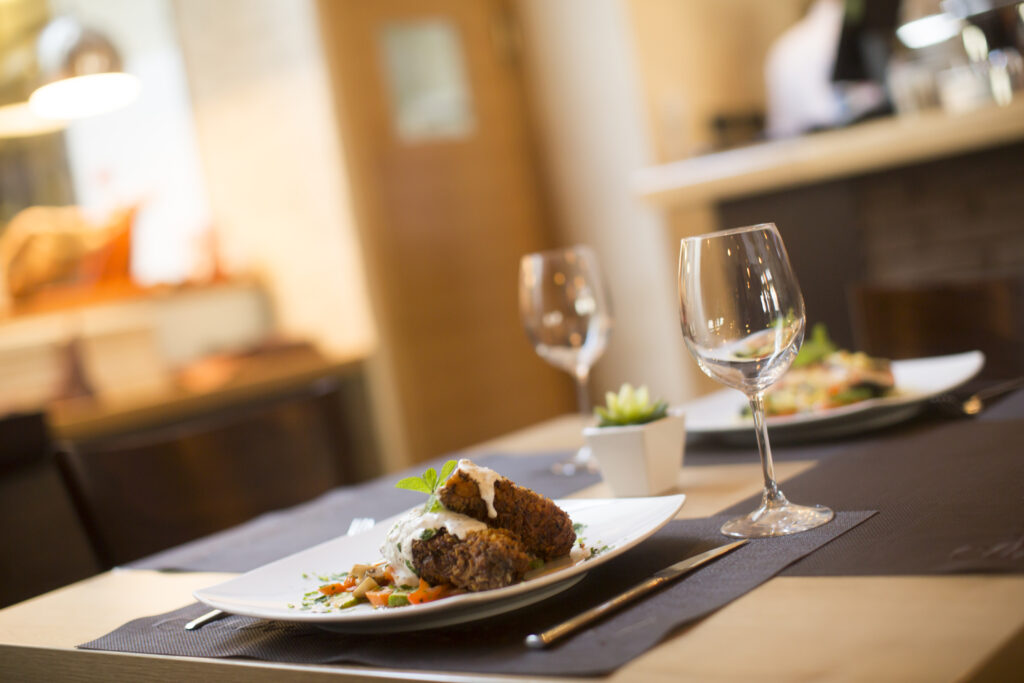 Grilled meat with sauce and herbs served at restaurant